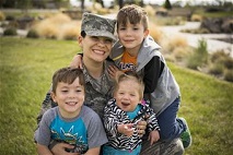 Tech. Sgt. Jamie Meadows-Valley, 366th Aerospace Medicine Squadron, poses for a photo with her twin sons, Wolfgang and Jaeger, and her newly adopted daughter Oleksandra at Mountain Home Air Force Base, Idaho, on May 6, 2014. (U.S. Air Force photo/Tech. Sgt. Samuel Morse)