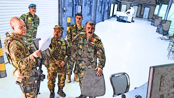 Lt. Col. Jose Lasso, Train, Advise, Assist Command-Air (TAAC-Air) deputy director of logistics, receives a tour of a flight simulator training facility from Afghan Air Force Brig. Gen. Abdul Qudratullah, Shindand Air Wing commander, at Herat, Afghanistan, March 1, 2017. This visit was an opportunity for advisors to have face-to-face interaction with their AAF counterparts. TAAC-Air headquarters is based out of Kabul, Afghanistan.