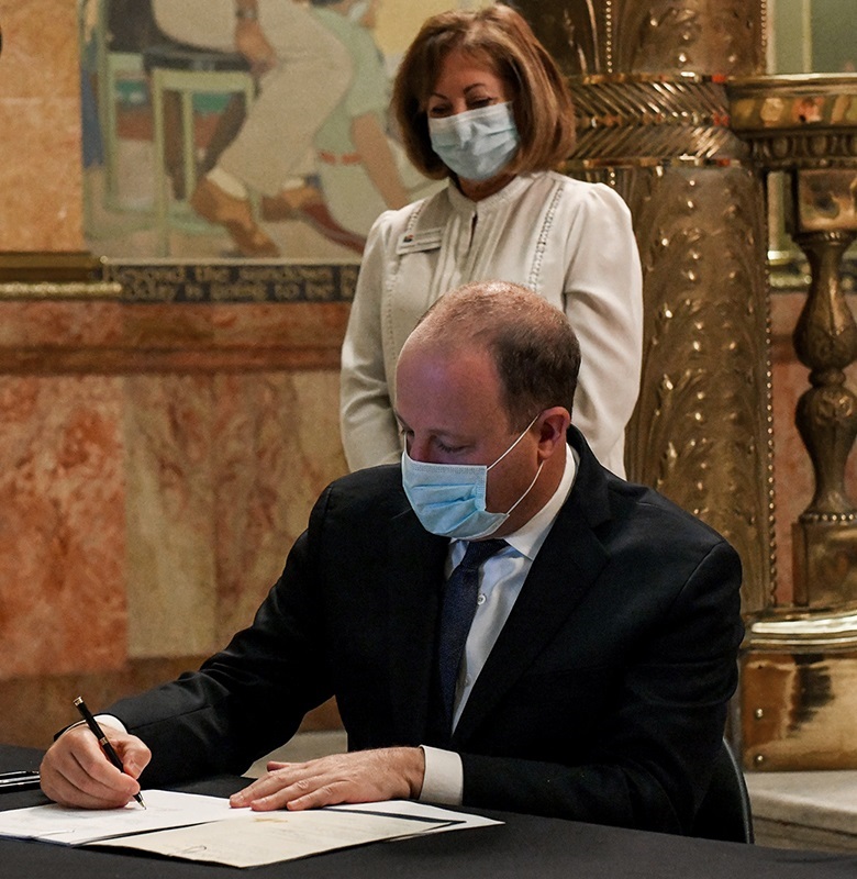 Colorado Governor Polis signs military legislation. Source: US Space Force.