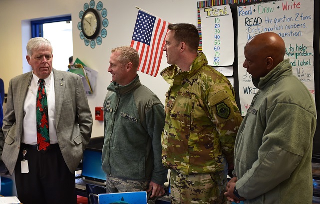 From left to right, William Husfelt, Bay District Schools Superintendent, Col. Brian Laidlaw, former 325th Fighter Wing Commander 2018-2020, Col. Jefferson Hawkins, 325 FW Vice Commander, and Chief Master Sergeant. Craig Williams, 325 FW Command Chief, wait for students to arrive during the re-opening of Tyndall Elementary School near Tyndall Air Force Base, Fla., December 10, 2018. Open for the first time since Hurricane Michael, approximately 200 of the original 750 students returned to school, many of whom have parents working at Tyndall. (U.S. Air Force)
