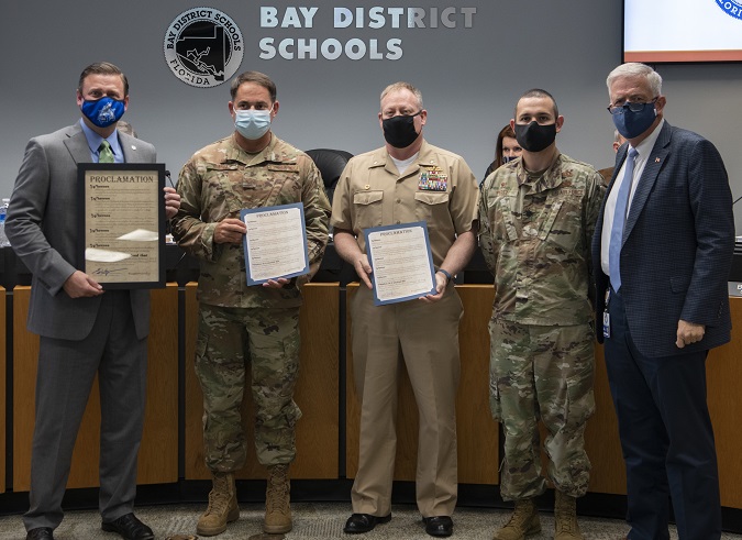 From left to right, Steve Moss, Bay District Schools Board Chairman, U.S. Air Force Col. Greg Moseley, 325th Fighter Wing Commander, U.S. Navy Cmdr. Keith Foster, Naval Support Activity Panama City Commanding Officer, U.S. Air Force Lt. Col. Rigoberto Perez, 325th Force Support Squadron Commander, and Bill Husfelt, Bay District Schools Board Superintendent, pose for a photo at Panama City, Florida, April 13, 2021. Leadership from Tyndall Air Force Base and Naval Support Activity Panama City signed an annual proclamation with the Bay District Schools board, designating April as Month of the Military Child to recognize students who are military dependents across all schools in the Bay County area. (U.S. Air Force)