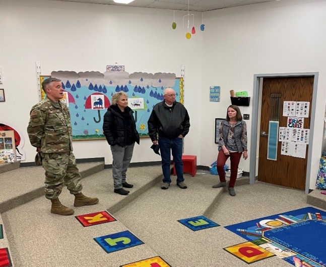 341st Mission Support Group Commander Col Christopher Karns, GFPS Assistant Elementary Superintendent Ruth Uecker, Montana MIC3 Commissioner Ray Shaw touring the Skyline Early Learning Family Center’s children’s library with Colette Getten, GFPS Transitional Kindergarten Coordinator.