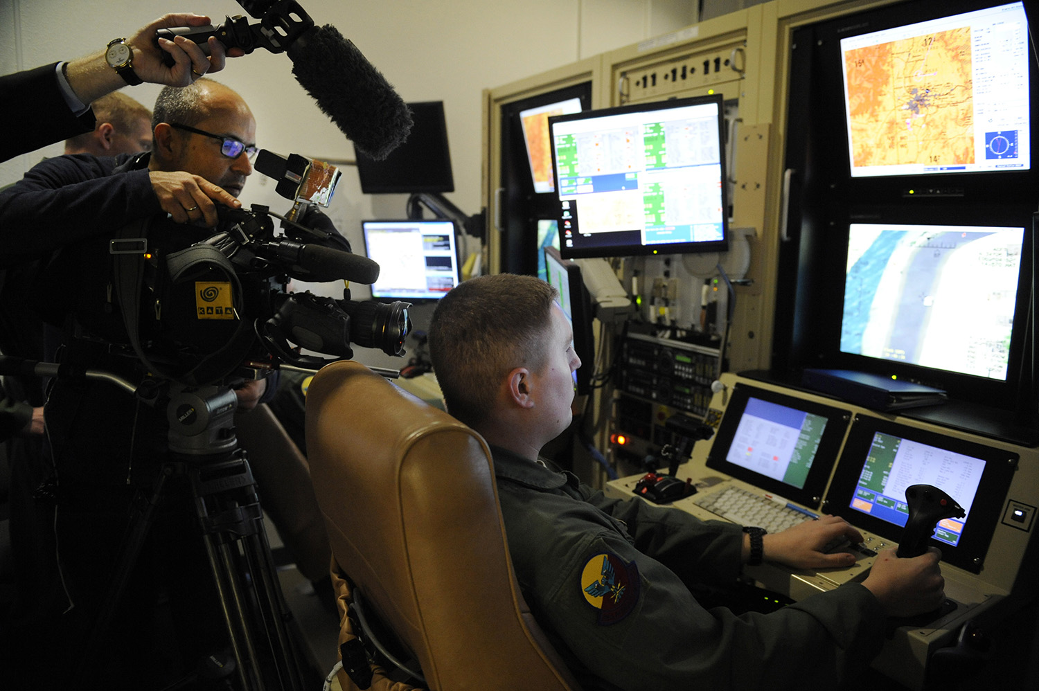 Local and international media outlets film a US Air Force sensor operator inside the 16th Training Squadron MQ-1/MQ-9 simulator at Holloman AFB, which served as a training base for crews of the MQ-1 Predator and the MQ-9 Reaper.