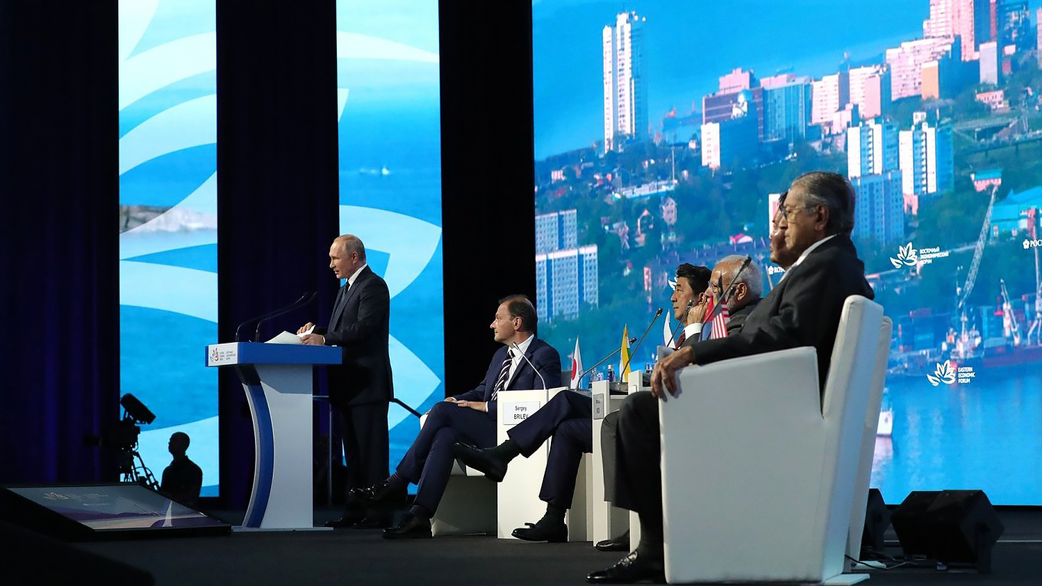 Russian President Vladimir Putin addresses the plenary session of the Eastern Economic Forum with Malaysian Prime Minister Mahathir bin Mohamad, Mongolian President Khaltmaagiin Battulga, Indian Prime Minister Narendra Modi, and Japanese Prime Minister Shinzo Abe sharing the stage.