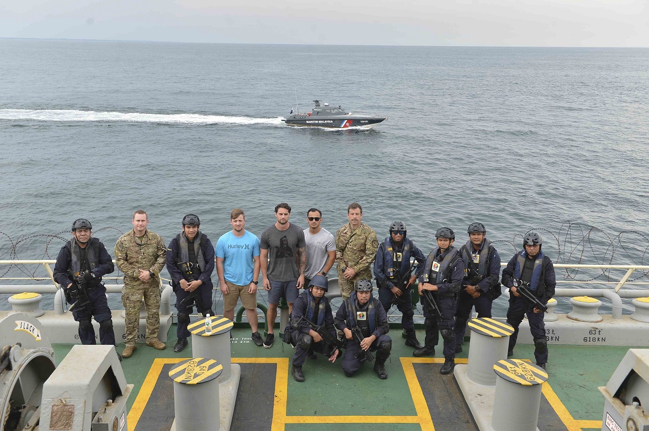 US Coast Guard Maritime Enforcement Specialists and Malaysian Maritime Enforcement Agency coast guardsmen pose for a group photo after conducting a visit, board, search-and-seizure training drill as part of Southeast Asia Cooperation and Training (SEACAT) 2019. This year marks the 18th iteration of SEACAT, which is designed to enhance maritime security skills by highlighting the value of information sharing and multilateral coordination. (US Navy photo by Mass Communication Specialist 2nd Class Tristin Barth)