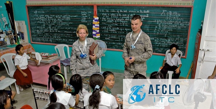 Two Airmen teaching a course to young students