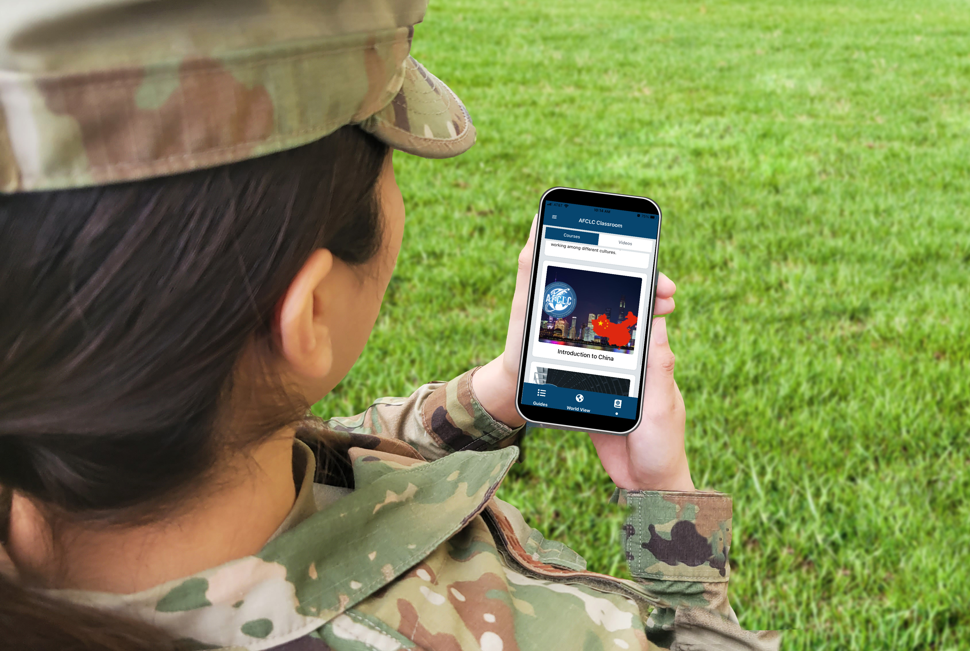 Airman holds Culture Guide Mobile App in their hands
