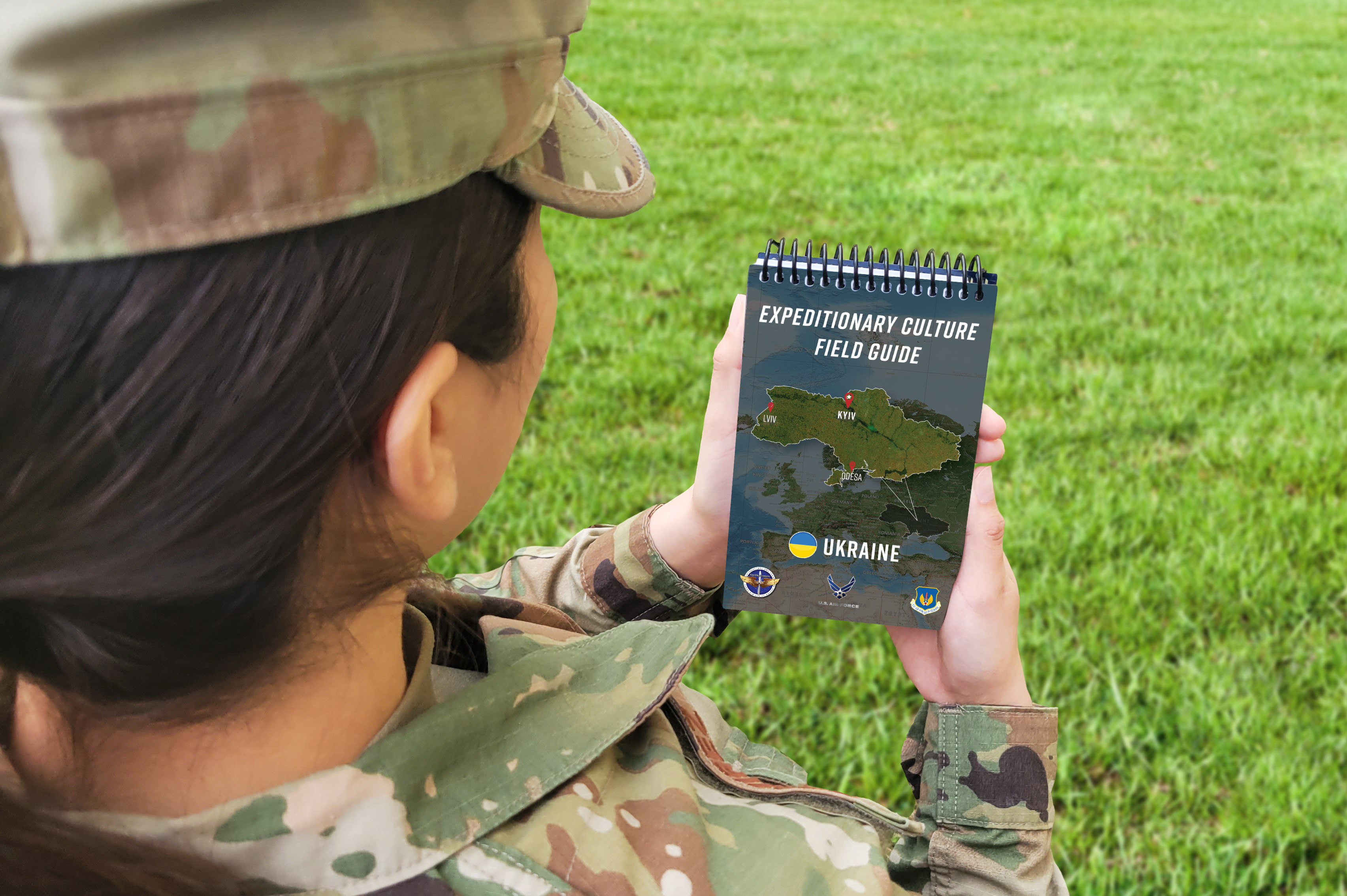 Airman holds field guide in their hands