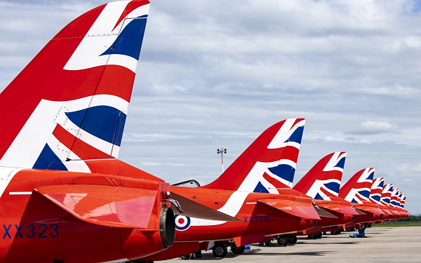 Image of tail fins of the Royal Air Force aerobatic team's aircraft, parked neatly on the flightline at RAF Fairford, England.