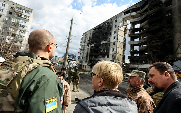 Prime Ministers of Ukraine and Lithuania both observe a destroyed apartment tower in the village of Borodyanka.