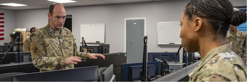 Two people speak in an office setting